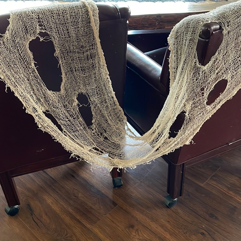 Gauzy spiderweb decor approximately 18 x 100”